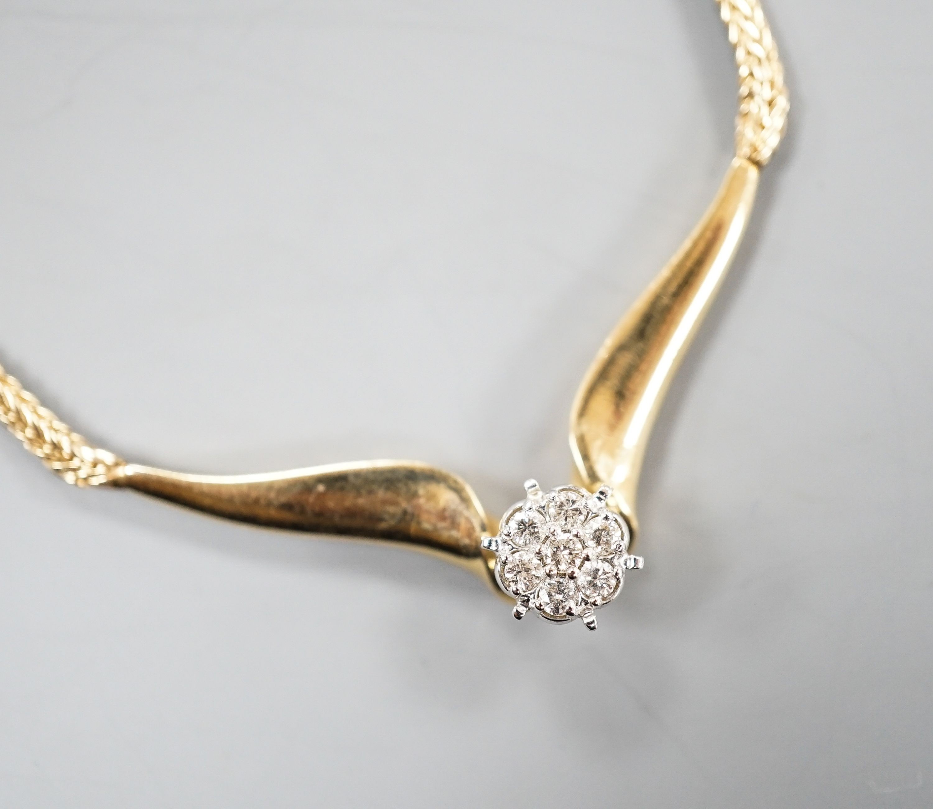 A modern 14k yellow metal and seven stone diamond cluster set necklace, 38cm, gross weight 12.3 grams.